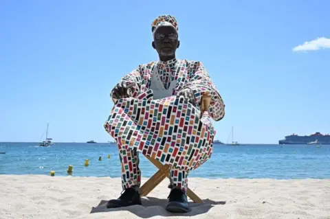 Stefano Rellandini/ AFP Malian director Souleymane Cissé poses on the sidelines of the 76th Cannes Film Festival in Cannes, France, on May 16, 2023.