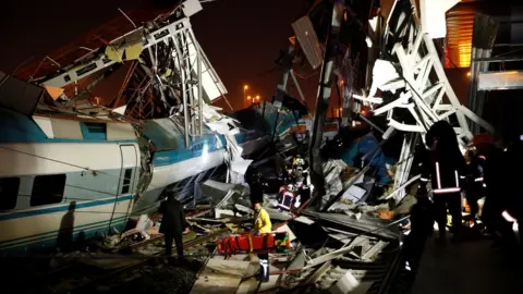 Anadolu Agency Rescue workers search the wreckage for survivors