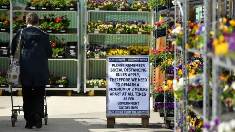 Getty Images A woman shops at a garden centre in Exeter