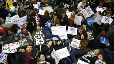 EPA Supporters of stricter gun control stage a "die in" during a solidarity rally with "March For Our Lives" outside the U.S. Embassy in London, Britain