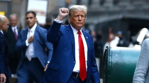 Getty Images Image shows Trump leaving court earlier this year