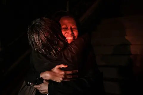 AFP A woman reacts as she is reunited with family after being evacuated from the DusitD2 compound in Nairobi after a blast followed by a gun battle rocked the upmarket hotel complex on January 15, 2019.
