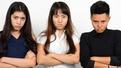 iStock Stock picture of three Asian women looking unimpressed
