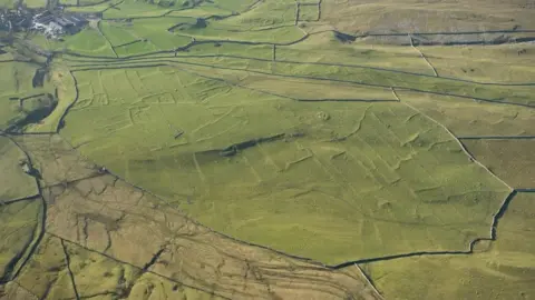 Historic England Remains seen beneath a field at Grassington