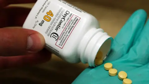 Reuters Tablets dispensed from a bottle of OxyContin into a gloved hand