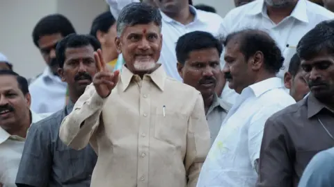 AFP Indian Telugu Desam Party President N.Chandra Babu Naidu (C) gestures as he greets his supporters after winning in the Indian election at his residence in Hyderabad on May 16, 2014