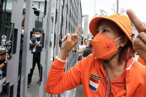 EPA A supporter of Move Forward Party"s leader and prime ministerial candidate Pita Limjaroenrat reacts after the Constitution Court suspended him from MP duty over his election rule violation case, outside the Parliament in Bangkok, Thailand, 19 July 2023.