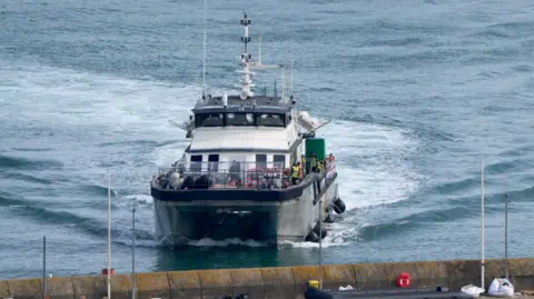 A photo of a group of people thought to be migrants are brought in to the Border Security Command compound in Dover, Kent, onboard a Border Force vessel following a small boat incident in the Channel