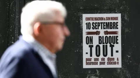 Reuters A poster for Let's Block Everything calls for a nationwide strike on 10 September