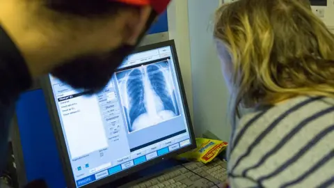 Getty Images Doctors looking at computer