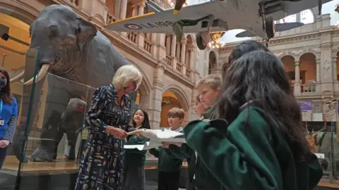 PA Media The Duchess of Cornwall Talks to school children as they hold a model of an albatross