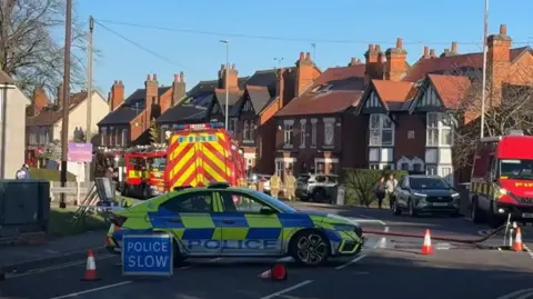 Leicester Media Online Police cars and fire engines on a closed road.