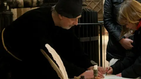 Peterborough Museum People in costume using quills