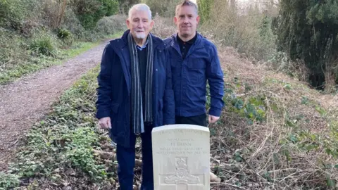 BBC Reg and Andrew in front of Harry Dunn's grave
