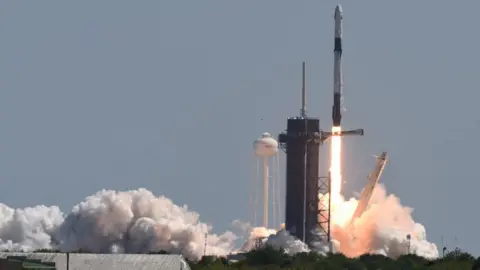 Getty Images A SpaceX Falcon 9 rocket with a Crew Dragon spacecraft and four private astronauts launches