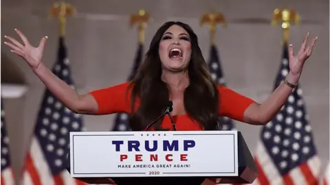 Getty Images Kimberly Guilfoyle holds outstretched arms as she speaks in Washington DC