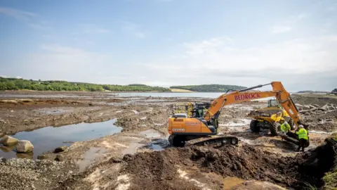 Removing sand from Dalgety Bay beach