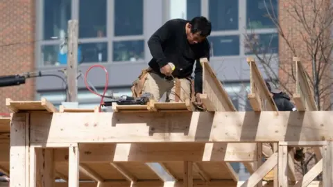 Getty Images A man works on construction