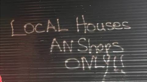 BBC Sunday's arson attack followed a recent racist graffiti attack on the shop
