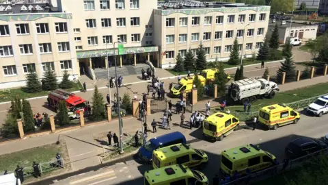 EPA Ambulances and other emergency services vehicles outside the school in Kazan, Russia, 11 May 2021
