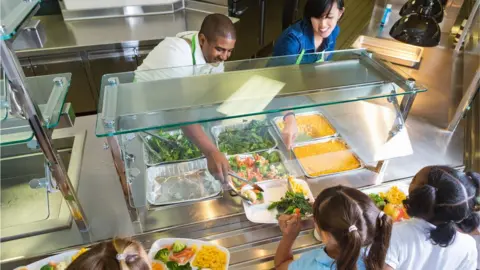 Getty Images Serving school meals