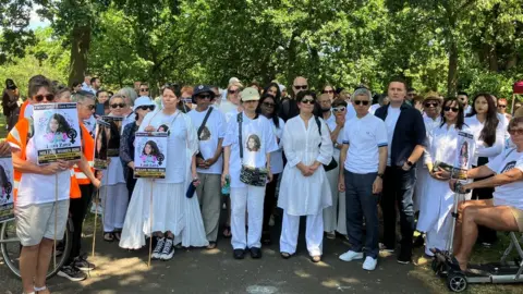BBC Zara Aleena's family alongside Sadiq Khan and Wes Streeting and other people at the vigil, all dressed in white