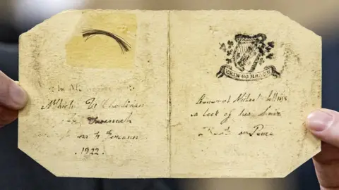 Liam McBurney/PA Media A keepsake card containing a lock of Michael Collins' hair