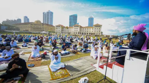 Getty Images Muslims wearing face masks pray to mark Eid while social distancing in Colombo on 1 August, 2020.