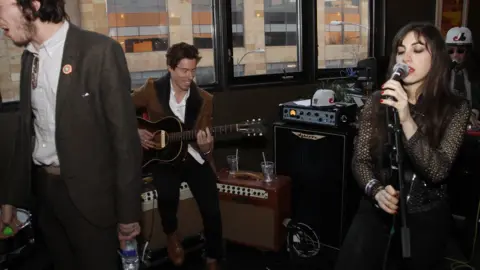 Getty Images Mr White on guitar and Ms Zawaideh singing