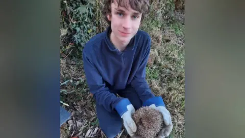 Emma Drabble Dylan with a hedgehog