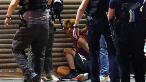 Reuters Riot police detain a man in Hong Kong. Photo: 6 September 2020
