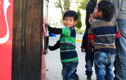 BBC Rogerio's son playing at Coca-Cola machine