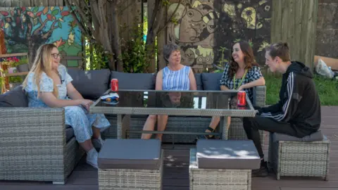 people sat around garden table