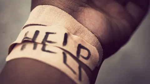 Getty Images A self harmed wrist covered with bandage