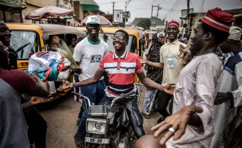 AFP People celebrate on February 27, 2019 in a street of Kano, the re-election of Muhammadu Buhari as Nigerian president