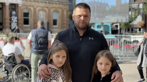 Dawn Gerber/BBC Steven and his daughters in Ipswich