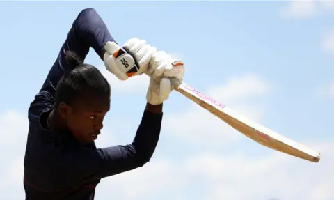 Getty Images Oluhle Siyo strikes the ball with her bat.