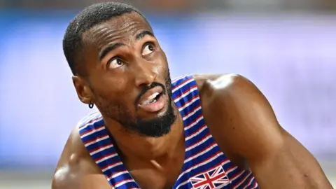 Matthew Hudson-Smith crouches on the track after winning world silver
