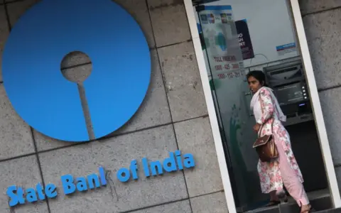 Getty Images A woman walks out of an ATM of State Bank of India (SBI) in Mumbai, India on 07 February 2020.