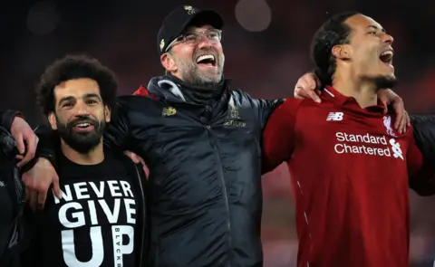 PA Media Mohamed Salah (left), manager Jurgen Klopp (centre) and Virgil van Dijk celebrate after the UEFA Champions League Semi Final