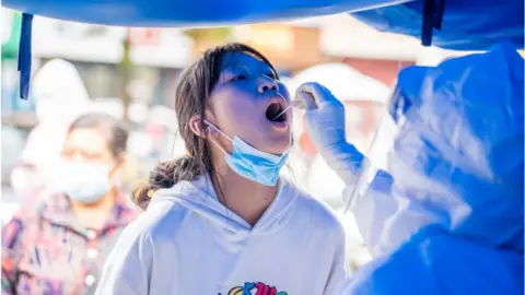 Getty Images A woman gets tested for COVID