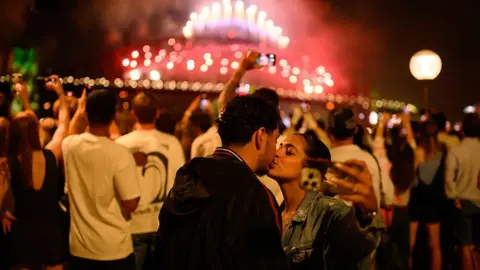 Two people kissing during the fireworks in Sydney 
