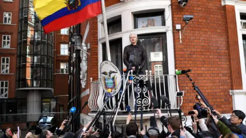 AFP Julian Assange speaks on a balcony of the Ecuadorian embassy in London, to a crowd of journalists below