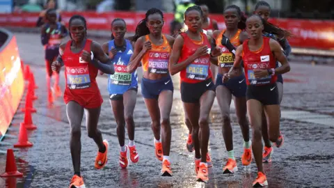 EPA Women runners in action during the London Marathon on 4 October 2020