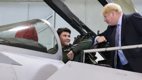 Getty Images Boris Johnson greets a pilot of a Typhoon jet in Scotland