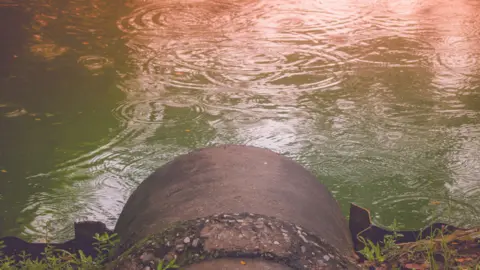 Getty Images Sewage pipe near water