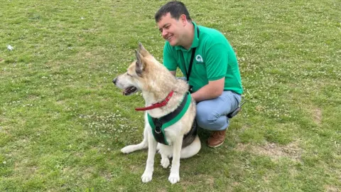 Theo Chikomba/BBC Chris Bennett from Woodgreen with a dog