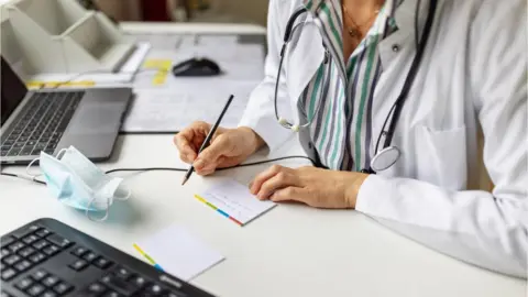 Getty Images A doctor making notes, stock image