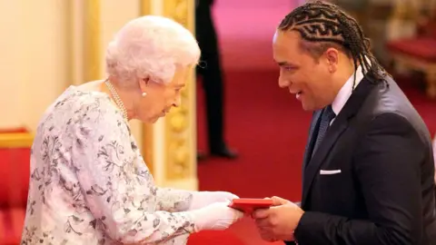 Getty Images Alex Holmes receiving his award