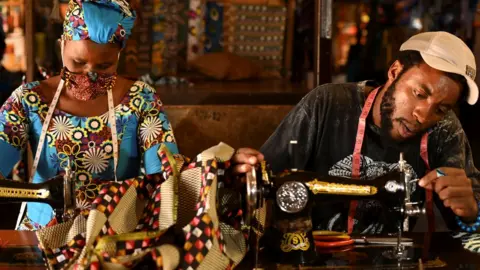 Reuters Tailors in Rwanda making traditional African fabric masks